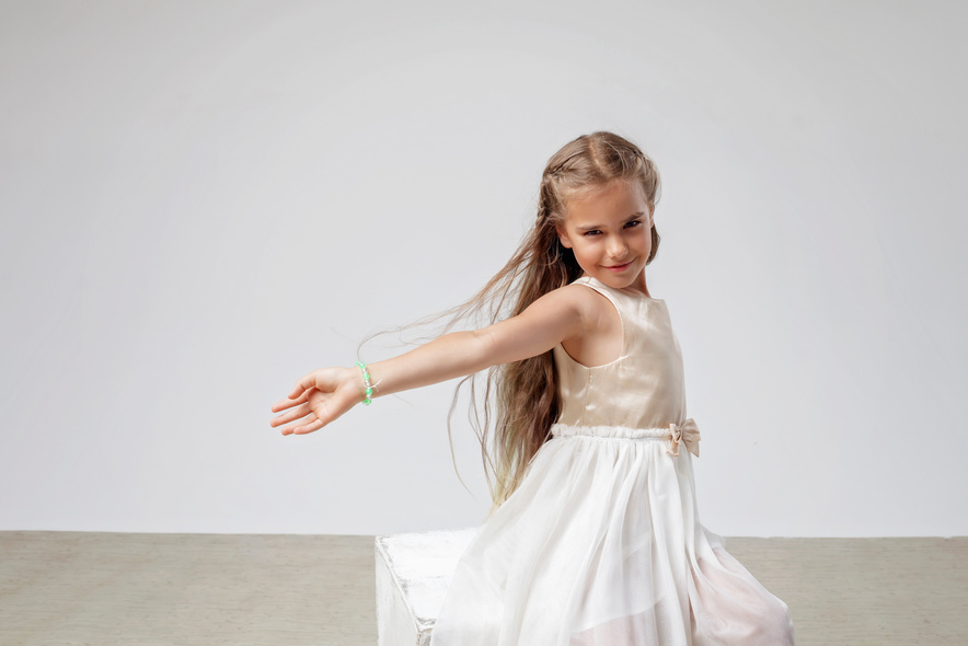 Girl with Long Hair in Festive Dress over White Background
